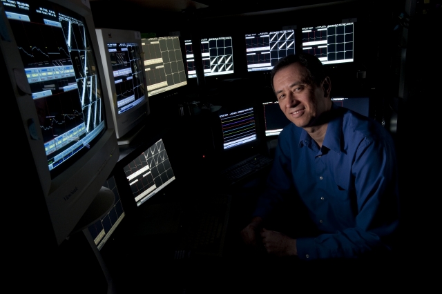 Photo of man with computer monitors