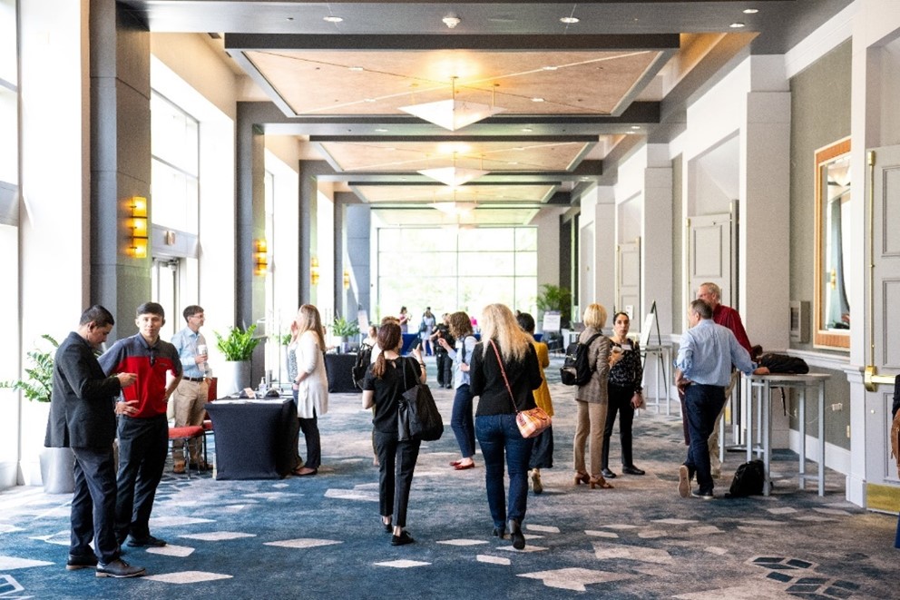 Attendees gathered in the hallway at the meeting.