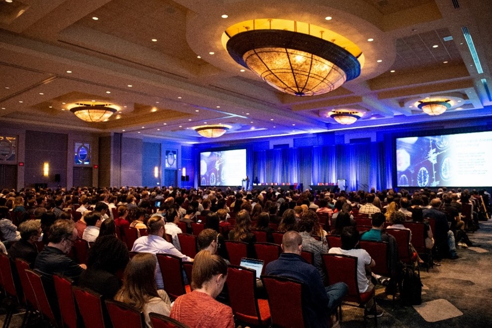 meeting attendees sitting in larger ballroom